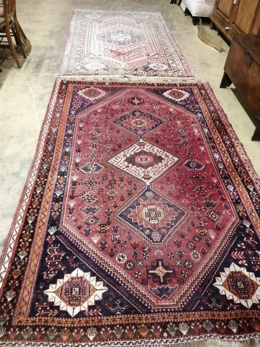 A Caucasian style peach ground rug, 260 x 160cm together with one other